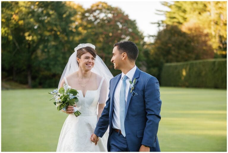 A bride and groom walking on a golf course.