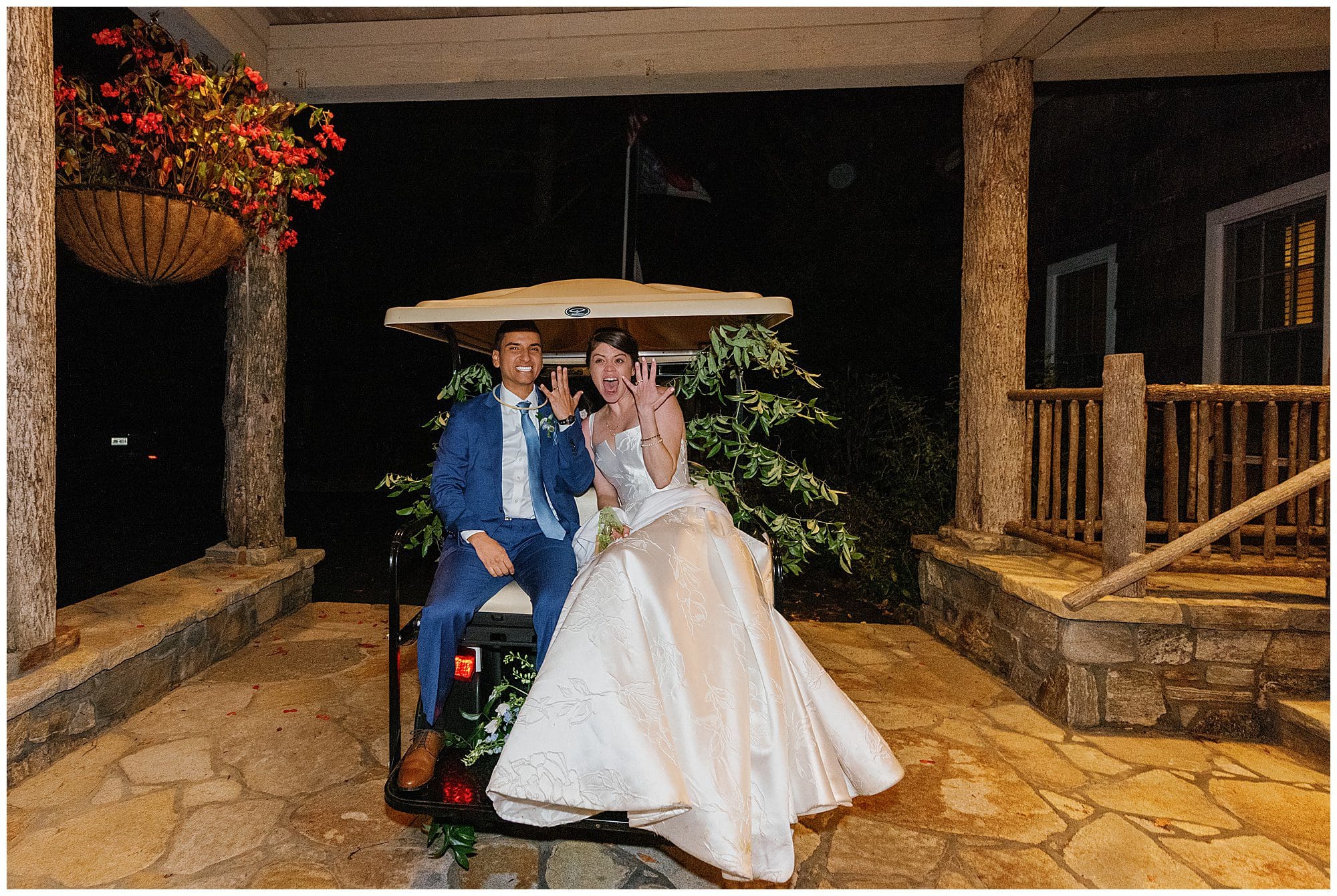 A bride and groom sitting on a golf cart at night.