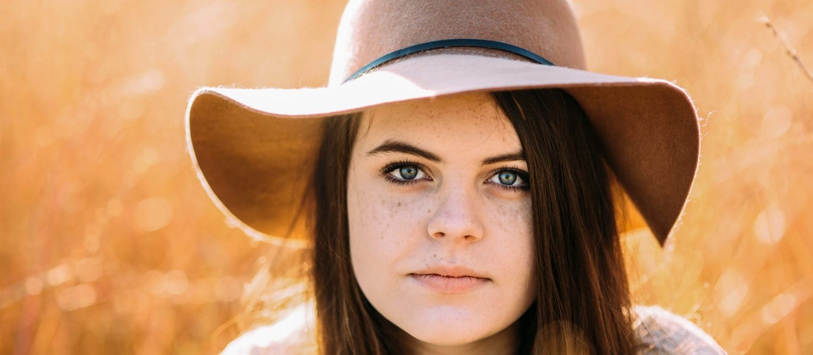 Girl in floppy hat at sunrise