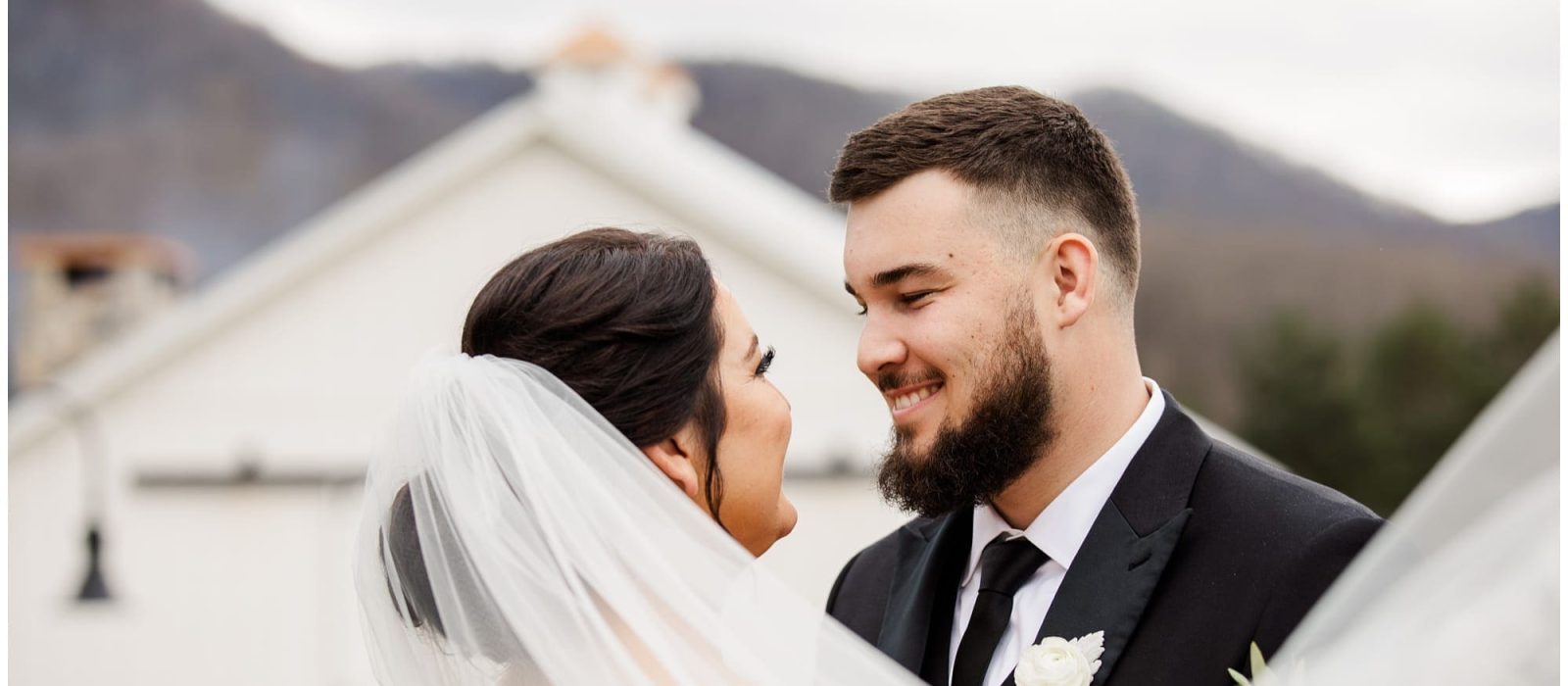 Veil Photo with bride and groom with venue in background