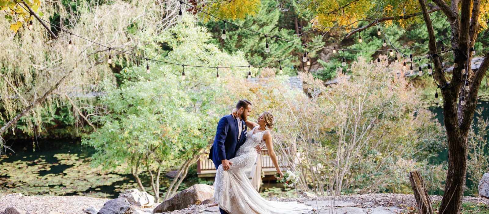 groom dips bride surrounded by fall colors at Honeysuckle Hill Wedding Venue