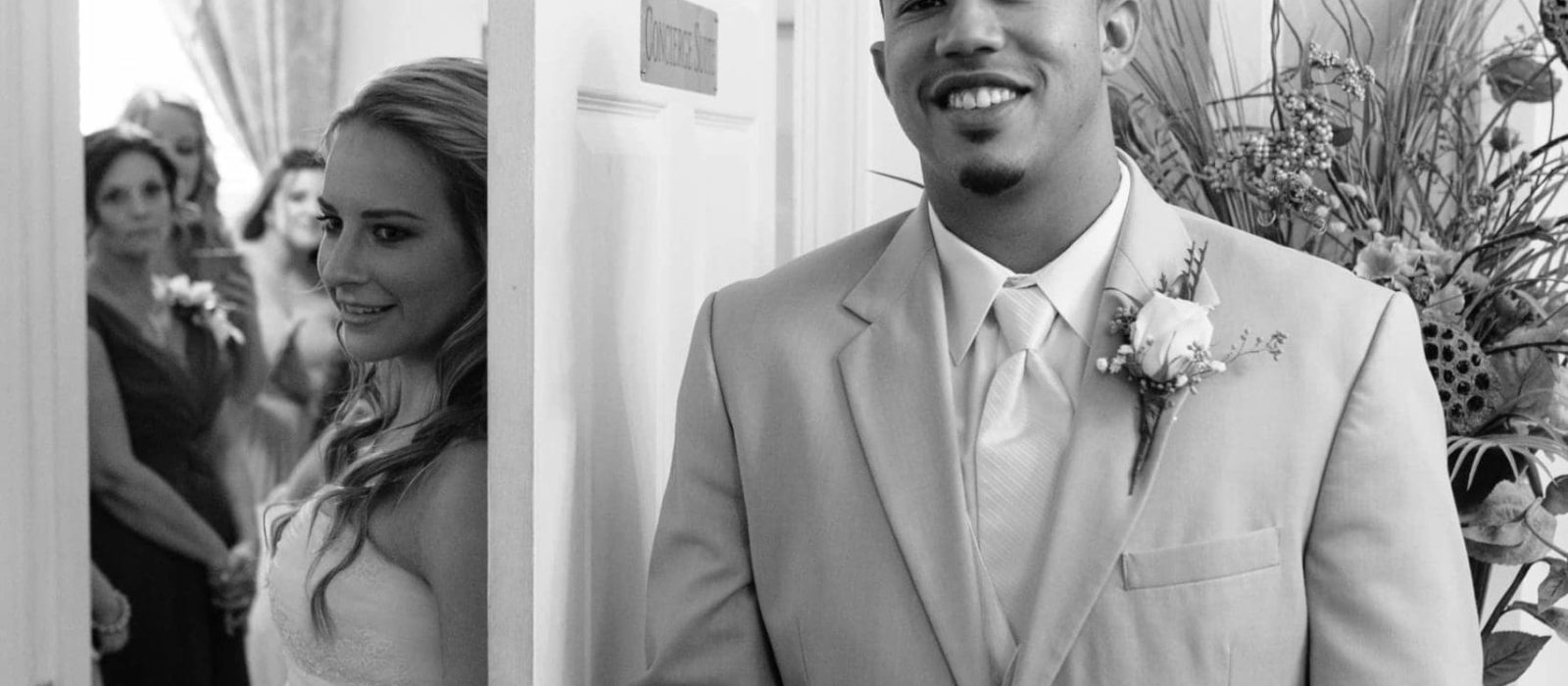 Asheville bride and groom holding hands behind door before wedding without seeing each other photography by Kathy Beaver